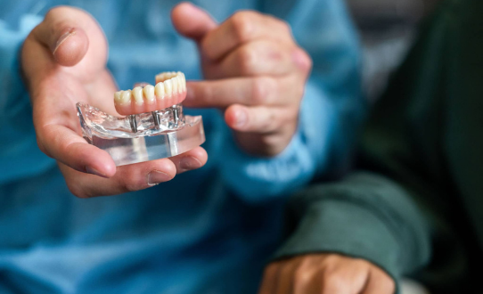 dental-specialist-showing-dental-implants-to-a-patient